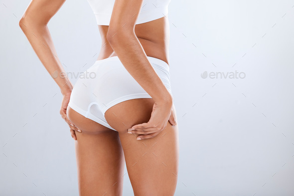 Woman, butt and white underwear in studio, dermatology spa and cellulite  skincare of body wellness. Stock Photo by YuriArcursPeopleimages
