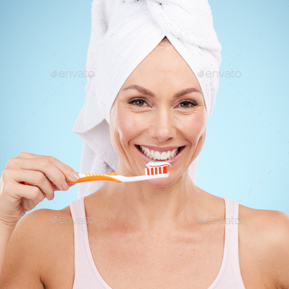 Portrait, woman smile and toothbrush isolated on blue background for dental, mouth or orthodontics