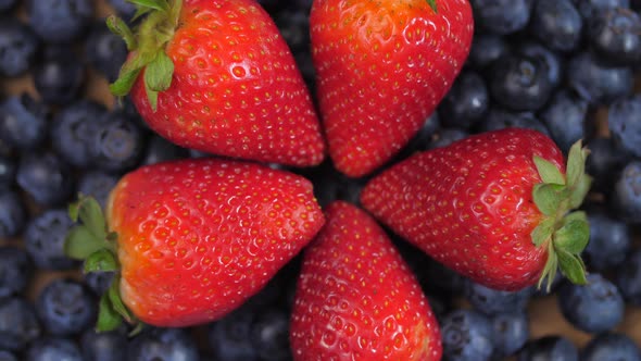 Close Up Of Strawberries Forming A Circle Laying On Top Of Blueberries Spinning 