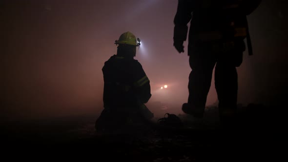 Rescue forces search for survivers inside a dark tunnel using flashlights alt