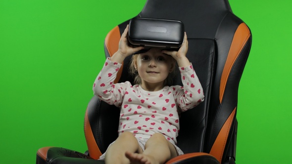 Child Girl Using VR Headset Helmet To Play Game. Watching Virtual Reality 3d 360 Video. Chroma Key alt