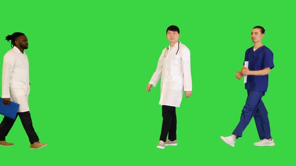 Multiracial Group of Young Doctors Come Together on a Green Screen Chroma Key