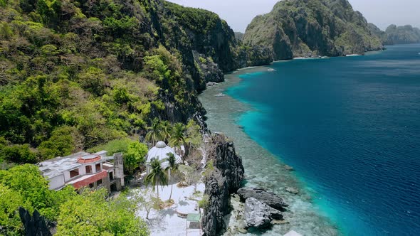 Aerial Fly Over Matinloc Shrine Along the Coastline alt