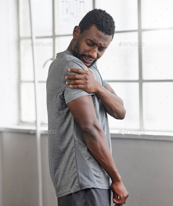 Shoulder injury, black man and pain in gym from exercise, medical emergency and injured muscle, bru