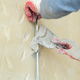 A hand with a spatula. Workers put putty on the wall with a spatula. Aligns wall. - PhotoDune Item for Sale