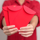 Woman holding Chinese red envelope - PhotoDune Item for Sale