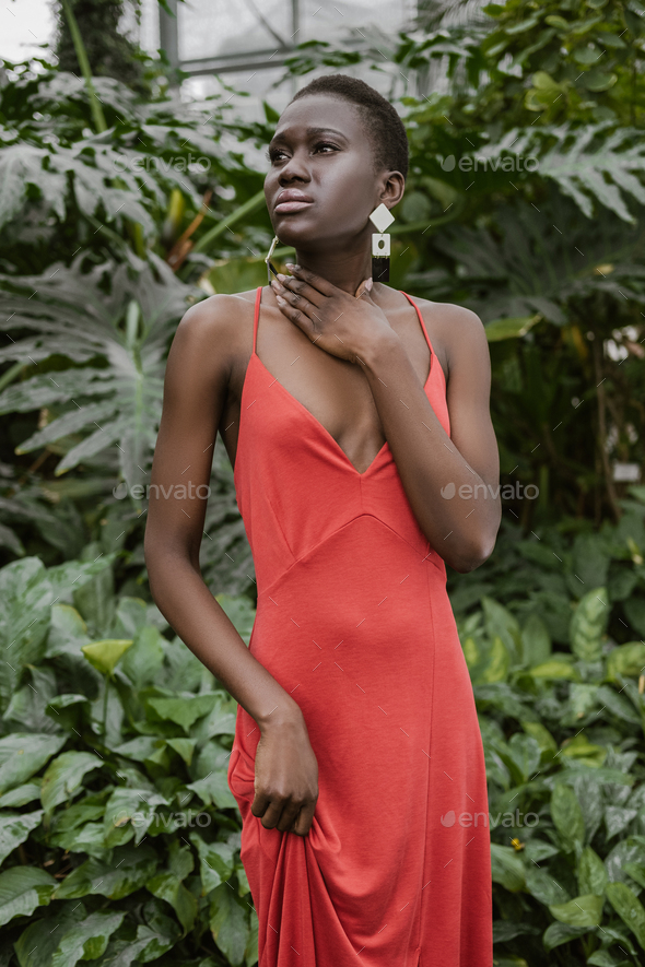 fashionable african american girl with short hair posing in trendy