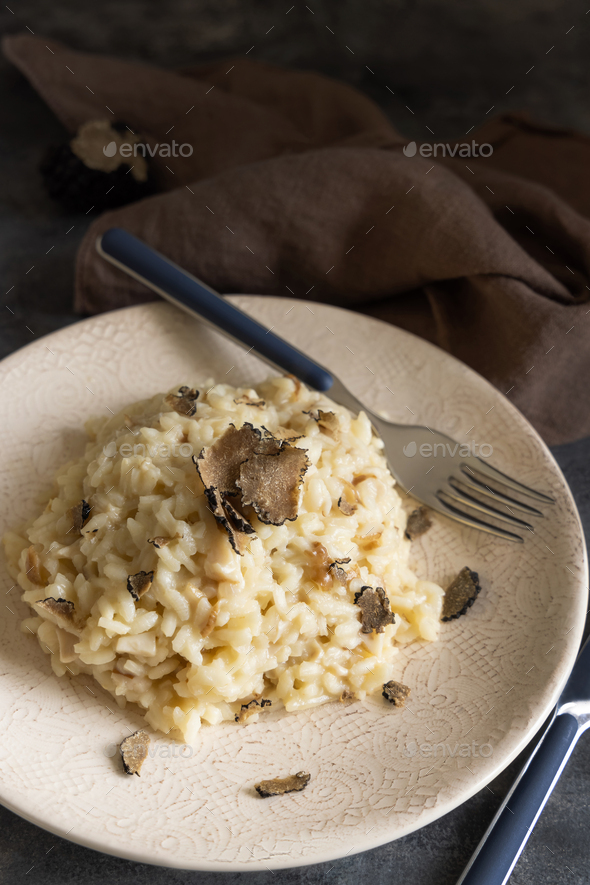 Risotto with porcini mushrooms and black truffles served in a plate top