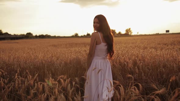 Smiling Lady in a Sundress Standing Outside