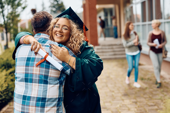 Happy graduate student embracing her father after graduation ceremony ...