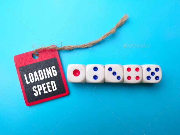 Dice and wooden board with the word LOADING SPEED. - Stock Photo - Images