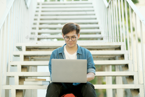 Student studying outdoor using laptop. - Stock Photo - Images