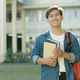 Student standing outdoor and holding books. - PhotoDune Item for Sale