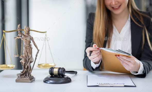 female intelligent law attorney lawyers working at the law firms. Judge gavel with scales of justice