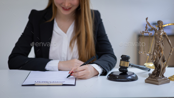 female intelligent law attorney lawyers working at the law firms. Judge gavel with scales of justice