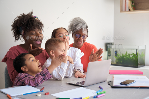 African family doing a video call on a laptop and sending kisses.