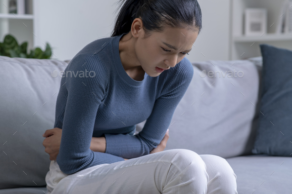 Woman suffering from strong abdominal pain - Stock Photo - Images