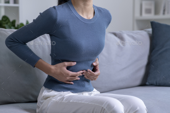 Woman suffering from strong abdominal pain - Stock Photo - Images