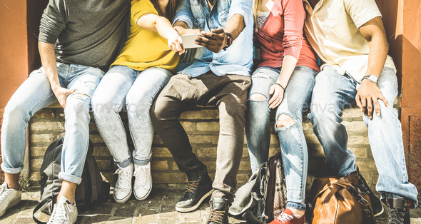 Group of multiculture friends using smartphone on urban background - Stock Photo - Images