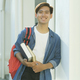 Student standing outdoor and holding books. - PhotoDune Item for Sale