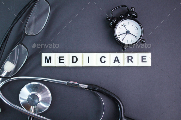 stethoscope, glasses, alarm clock with the alphabet word medicare ...