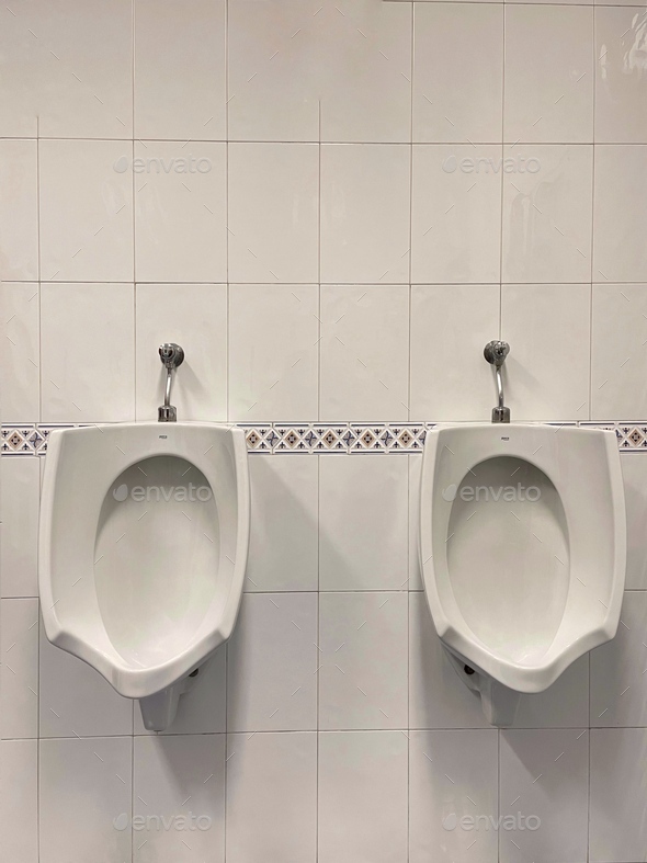 View of toilets attached to the wall in the public bathroom Stock Photo by wirestock