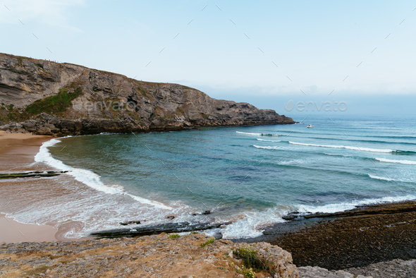 View of Antuerta Beach. Beach surrounded by cliffs and very popular for surfers - Stock Photo - Images