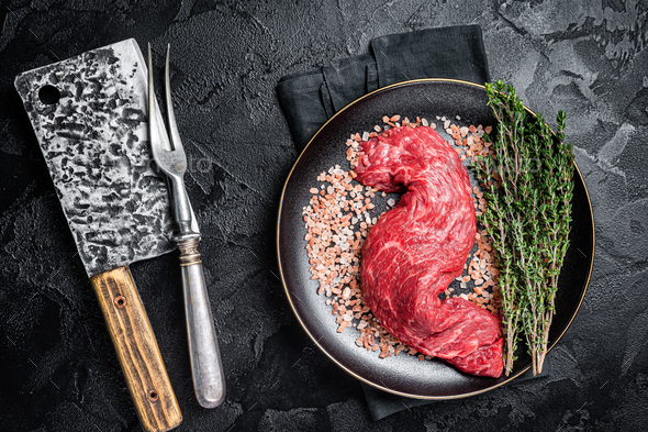 Raw skirt machete beef meat steak on a cutting board with knife. wooden  background. Stock Photo by composter-box