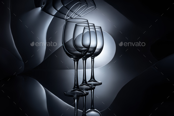 row on empty luxury wine glasses, dark studio shot Stock Photo by