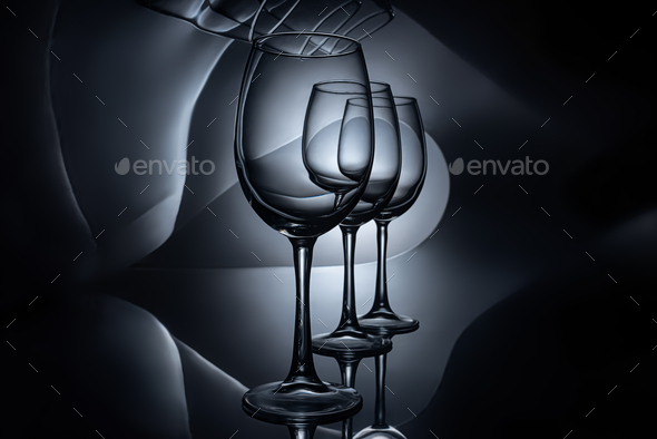 row on empty luxury wine glasses, dark studio shot Stock Photo by