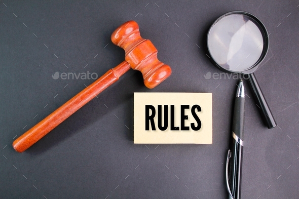magnifying glass, pen and judge's gavel with the word RULES.  - Stock Photo - Images