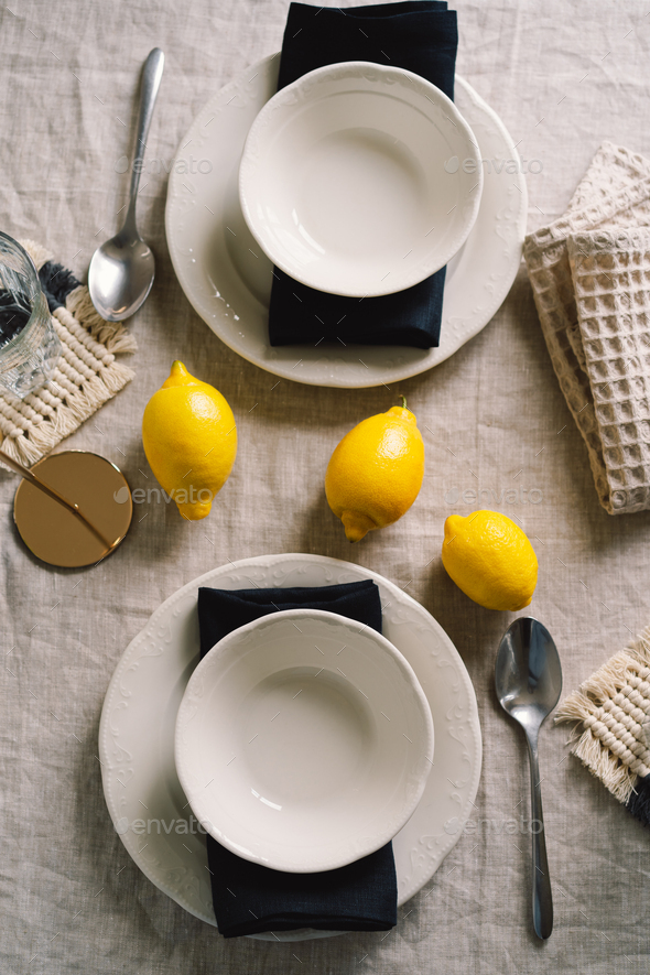 Vintage table setting with Linen napkins and yellow lemons. - Stock Photo - Images
