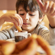 elementary age kid dipping churros into a hot chocolate mug - PhotoDune Item for Sale