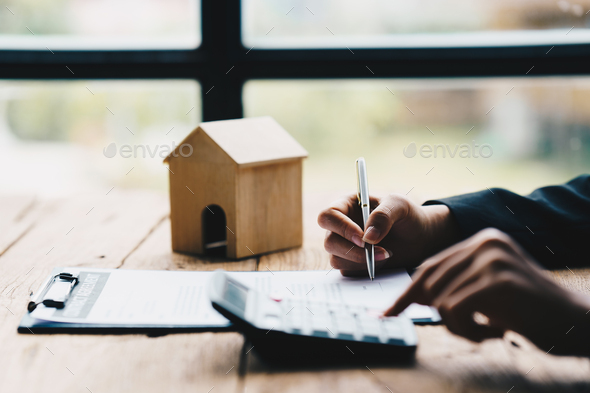Signing House Rental Contract Document concept, House model with agent and customer discussing
