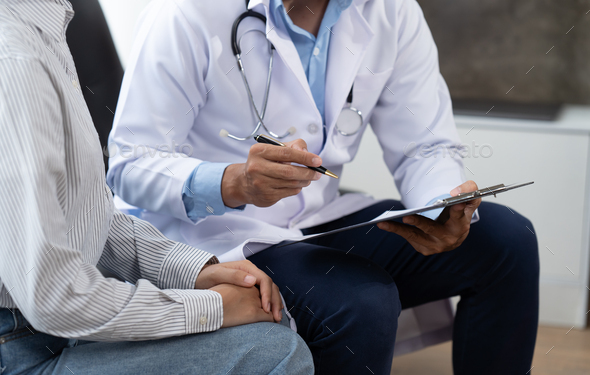 Doctor and patient sitting and talking at medical examination at