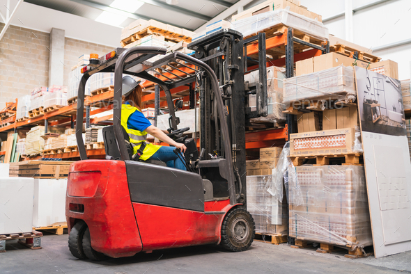 Spanish woman worker using a forklift in a warehouse Stock Photo by ...