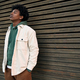 Cool young hipster gen z African American teen standing at wooden wall. - PhotoDune Item for Sale