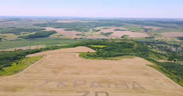 Tractor Plowed The Inscription In The Field  Ukraine alt