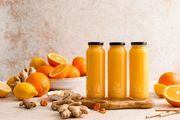 Smoothie. Healthy fresh raw detox citrus smoothie with orange, lemon, ginger and turmeric in a glass - Stock Photo - Images