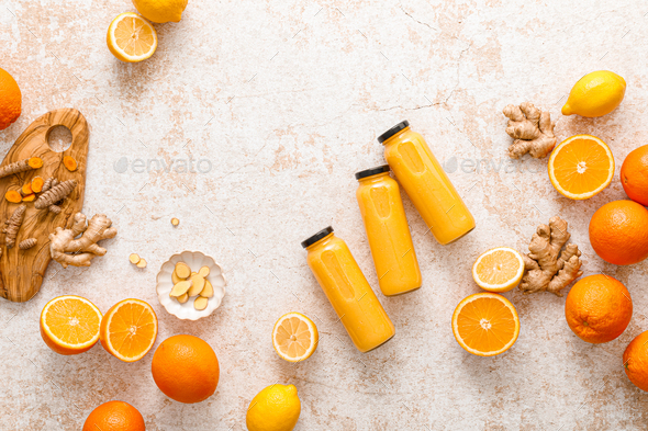 Smoothie. Healthy fresh raw detox citrus smoothie with orange, lemon, ginger and turmeric in a glass - Stock Photo - Images