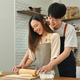Loving young husband and wife have fun making bread in kitchen, enjoying spending weekend time - PhotoDune Item for Sale