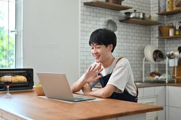 Cheerful young man freelancer checking email in morning, working online on laptop . - Stock Photo - Images