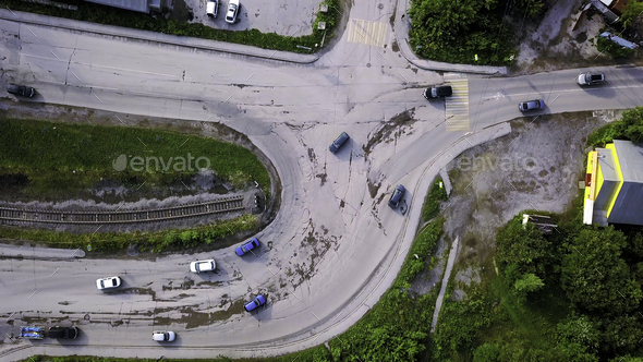Aerial view of the concrete road leading to the industrial zone. Clip. Cars driving near green - Stock Photo - Images