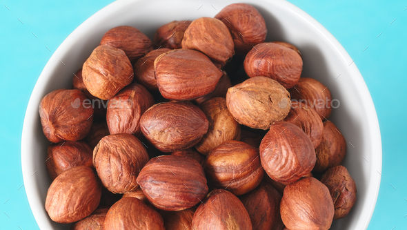 Close up picture of organic hazelnuts in a bowl, selective focus. - Stock Photo - Images