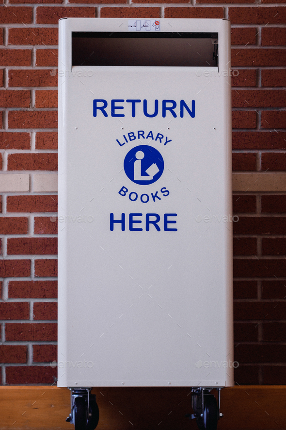 White library book return bin with the words 