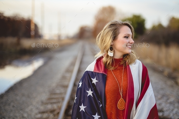 White female covered in the flag of the United States of America