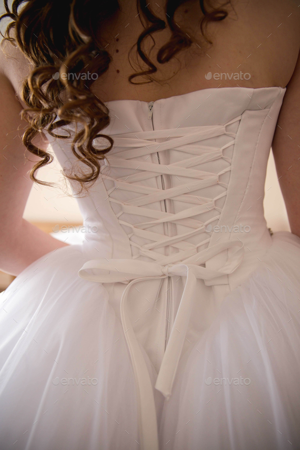 Vertical back view of a bride in a dress with a corset back Stock