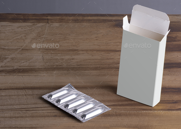 Suppositories loaf and empty box on a wooden table, mockup template