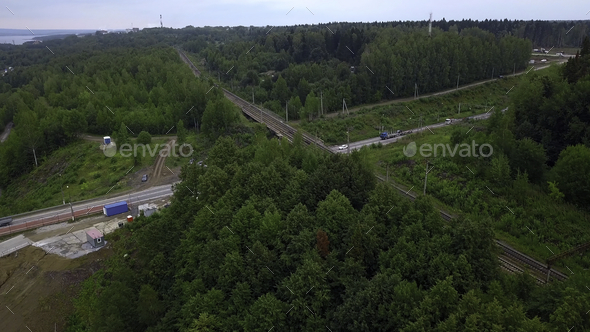 Road next to forest and river. Drone view. Clip.Dirty meandering river in the forest next to tall - Stock Photo - Images