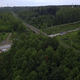 Road next to forest and river. Drone view. Clip.Dirty meandering river in the forest next to tall - PhotoDune Item for Sale